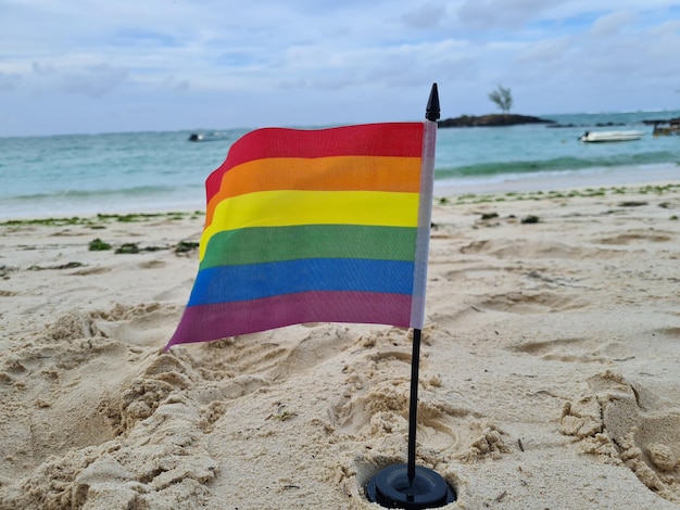 Bandera LGBT en vacaciones gratis en la playa del mar