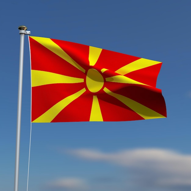 La bandera de Macedonia está ondeando frente a un cielo azul con nubes borrosas en el fondo
