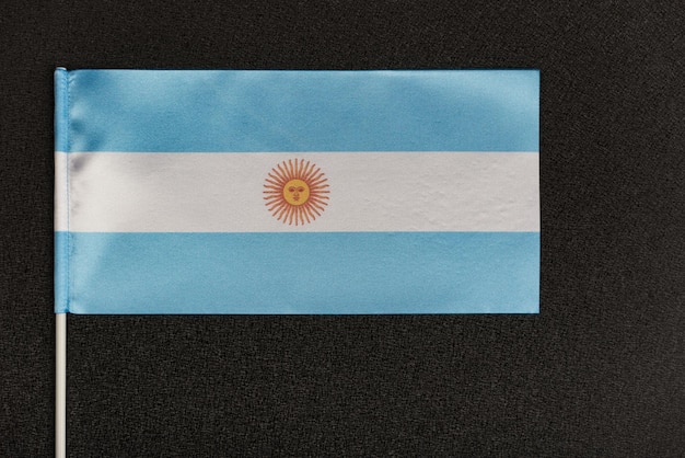 Foto bandera de mesa de argentina sobre fondo negro bandera azul y blanca con sol