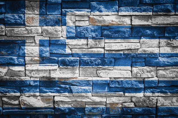La bandera nacional de Grecia sobre fondo de pared de piedra