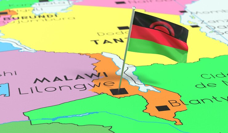 Foto la bandera nacional de malawi lilongwe fijada en el mapa político ilustración en 3d
