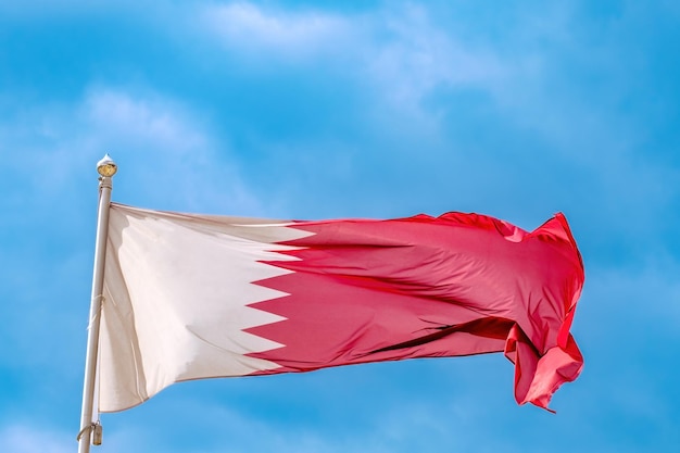 Bandera nacional de qatar ondeando en el viento