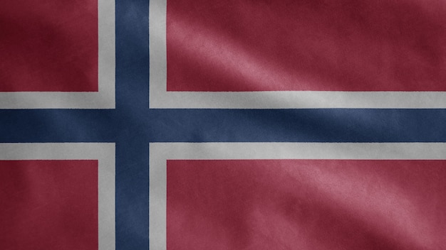 Bandera noruega ondeando en el viento. Cerca de plantilla de Noruega soplado, seda suave y lisa. Fondo de la bandera de la textura de la tela del paño. Úselo para el concepto de ocasiones de día nacional y país