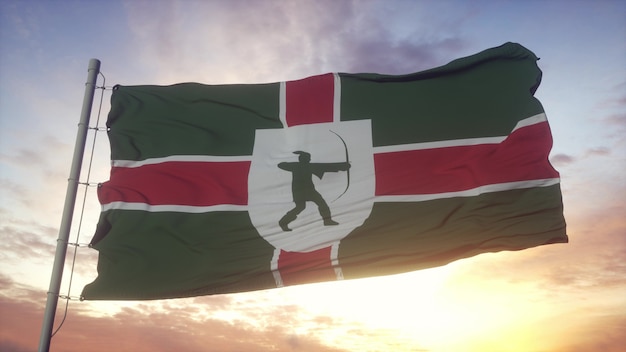 Bandera de Nottinghamshire, Inglaterra, ondeando en el fondo del viento, el cielo y el sol. Representación 3D.