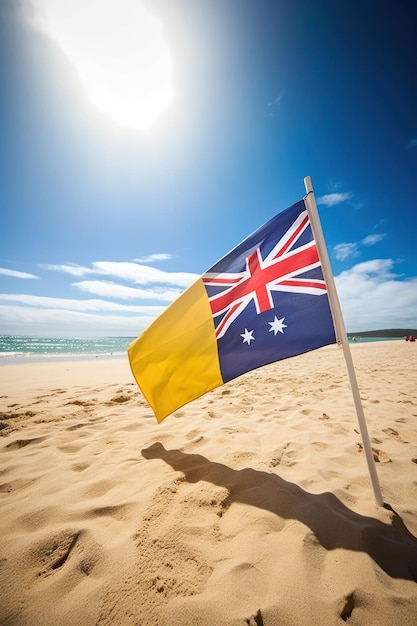 Una bandera en una playa con la bandera australiana en la arena.