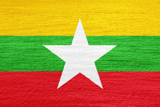 Foto bandera de la república de la unión de myanmar en un fondo texturizado collaje conceptual