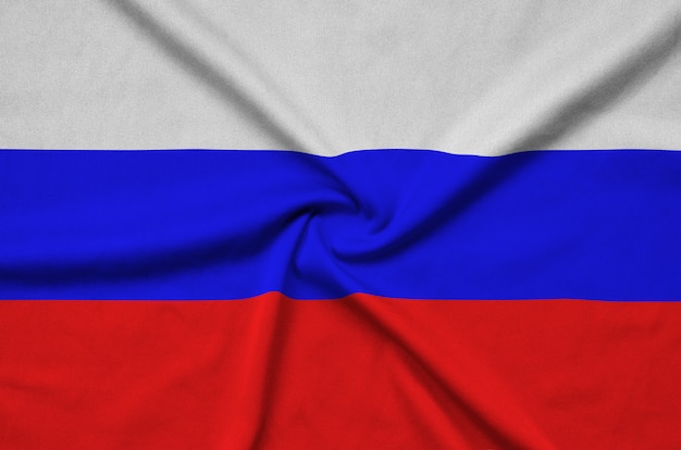 Foto la bandera de rusia está representada en una tela de tela deportiva con muchos pliegues.