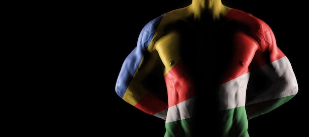 Bandera de Seychelles en torso masculino musculoso con abs, fondo negro