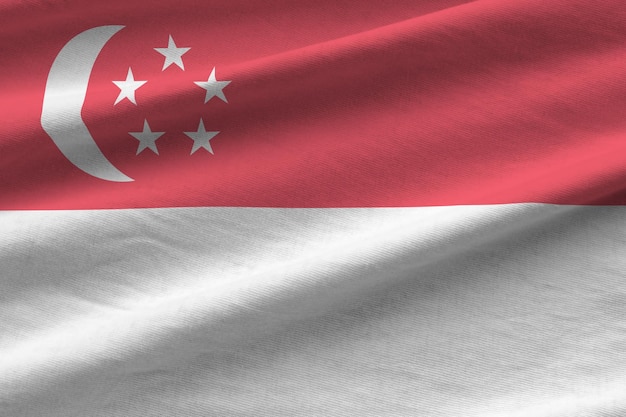 Bandera de Singapur con grandes pliegues ondeando de cerca bajo la luz del estudio en el interior Los símbolos y colores oficiales en la pancarta