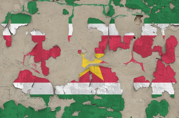 Foto bandera de surinam representada en colores de pintura en el antiguo muro de hormigón desordenado antiguo closeup.