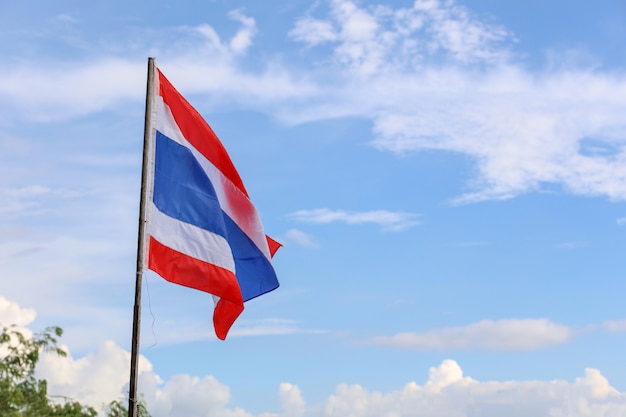 La bandera de Tailandia en el poste de madera tiene fondo de cielo