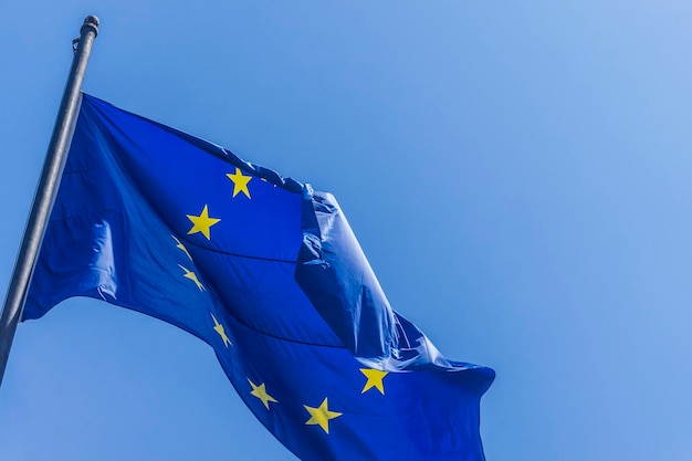 Bandera de la Unión Europea ondeando sobre un fondo de cielo azul