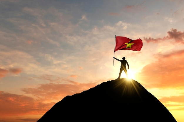 Bandera vietnamita ondeando en la cima de una cumbre de montaña d renderizado