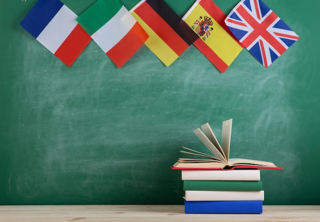 Foto banderas de españa francia gran bretaña y otros países y libros sobre el fondo