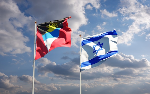 Banderas del estado de Israel y Antigua y Barbuda juntos sobre fondo de cielo