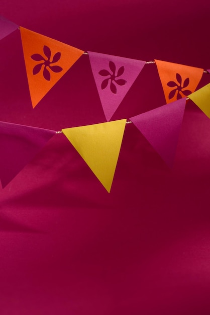 Banderines de papel coloridos contra el fondo magenta brillante Guirnalda de papel en colores festivos tradicionales de México