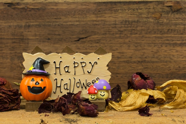 Foto banner de feliz halloween con flor seca sobre fondo de madera