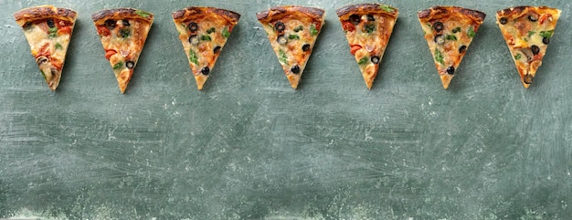 Foto banner mehrere pizzastücke auf grünem hintergrund