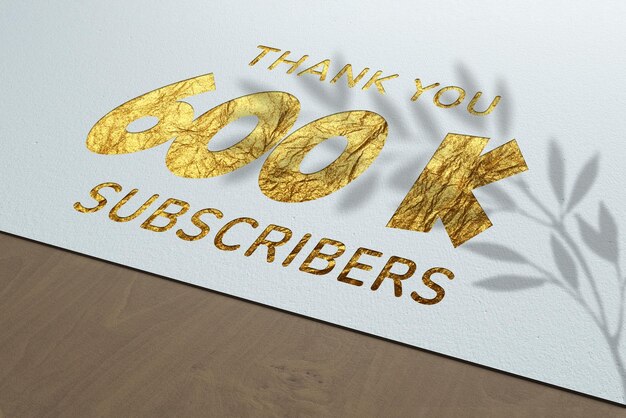 Banner de saludo de celebración de 600 K suscriptores con diseño de papel dorado
