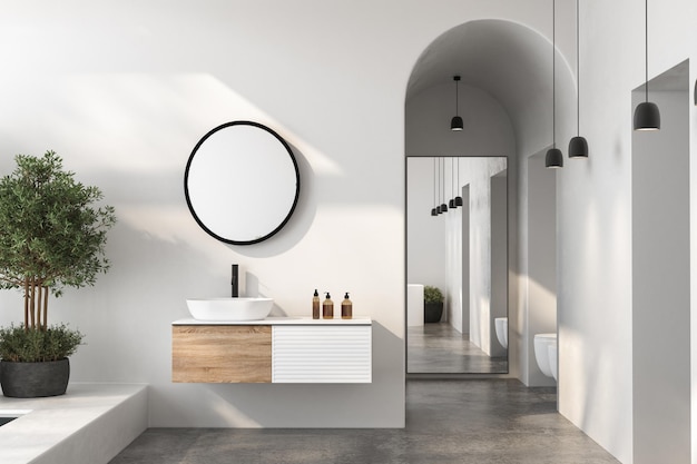 El baño minimalista suave, natural y sofisticado tiene un lavabo blanco, un espejo ovalado, un inodoro, un bidé y una piscina.