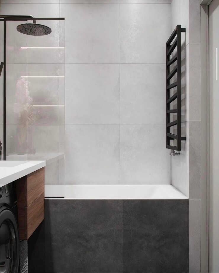 un baño con un piso de azulejos blancos y una bañera negra y blanca