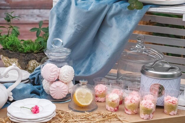 Banquete mesa de postres decorada en estilo rústico decorado con platos cubiertos vasos velas