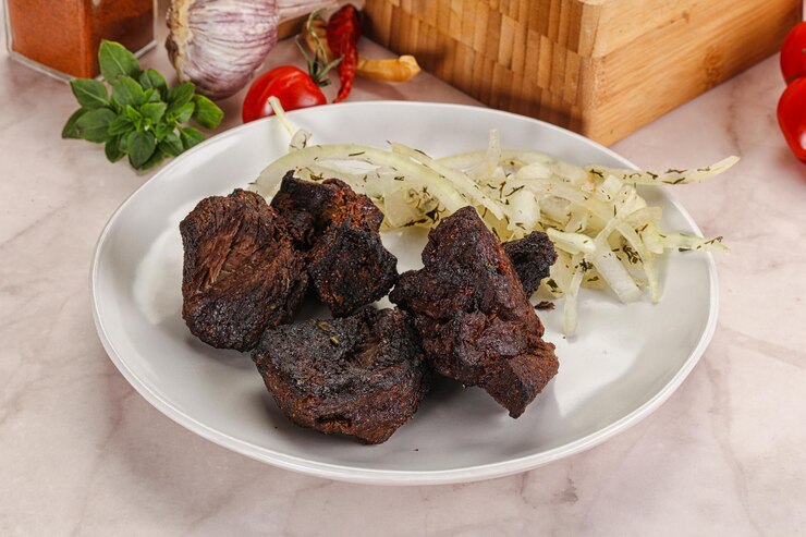 Foto barbequinho de carne grelhada servido com cebola