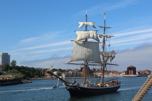 Foto barco a vela a navegar no mar contra o céu