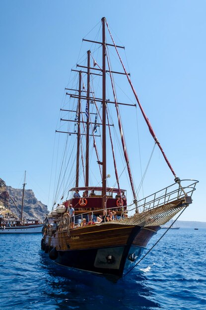 Barco a vela a navegar no mar contra um céu azul claro