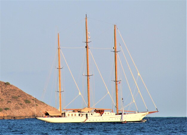 Foto barco a vela a navegar no mar contra um céu claro