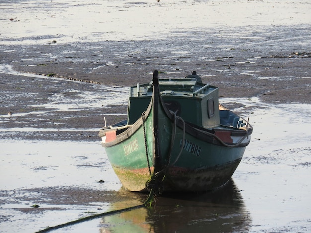 Foto barco amarrado en la orilla del río