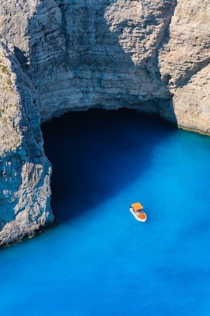 Un barco en la laguna cerca de la playa de Navagio Isla de Zakynthos Grecia Vista de la bahía del mar y un barco solitario desde un dron Agua de mar azul Vacaciones y viajes Paisaje de verano desde el aire