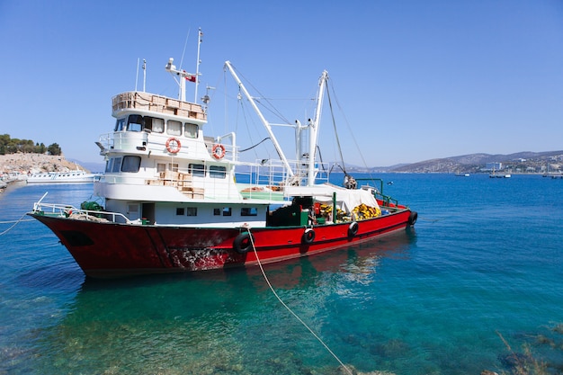 Un barco de pesca rojo sentarse en el muelle en un cálido día de verano en Turquía Kusadasi