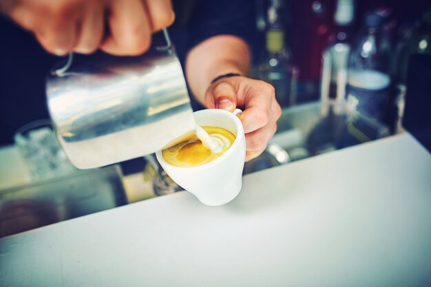 Barista bereitet Kaffee, Latte, Espresso zu.