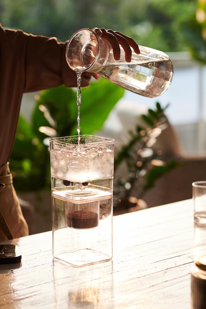 Foto barista despejando água na cafeteira