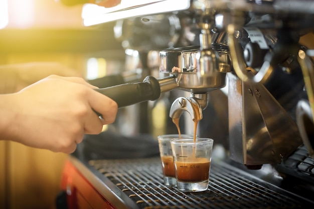 Barista haciendo tomas perfectas de café en la máquina de café