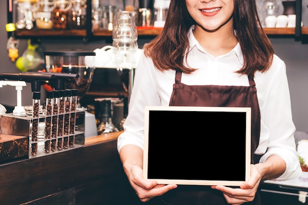 Barista segurando a lousa no restaurante da loja de café