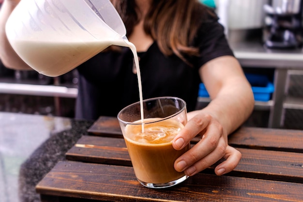 Barista serviert eine Tasse frischen Kaffee für Sie