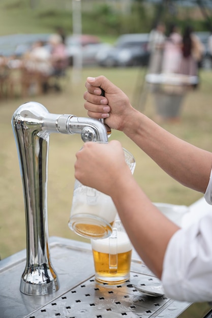 Barman, derramando cerveja de pressão da máquina da torneira