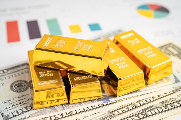 Barra de ouro em dinheiro de notas de dólar americano e conceito de investimento em comércio de câmbio financeiro de economia de gráfico