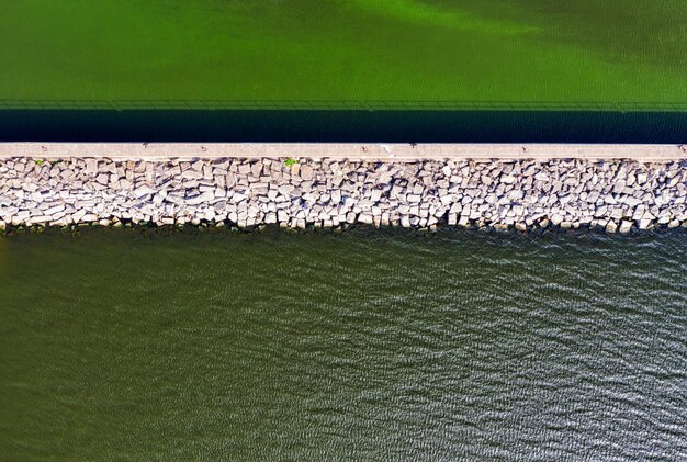 Barragem com pedras perto do rio Foto