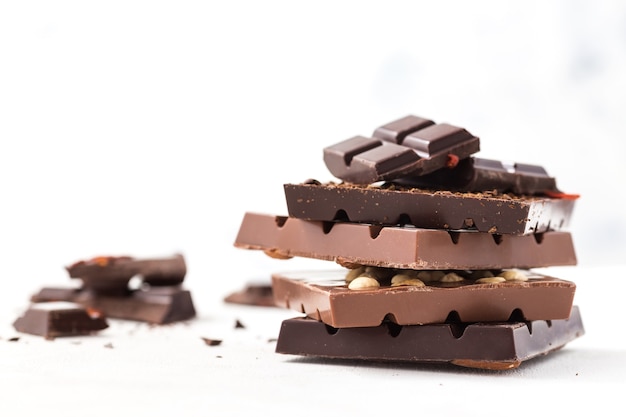 Barras de chocolate com goji berries e grãos de café em um fundo branco