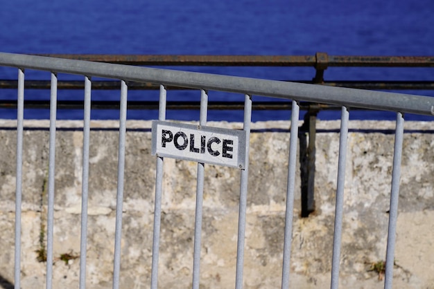 Las barreras policiales señalan texto en la ciudad de Mónaco al lado de la playa del mar azul
