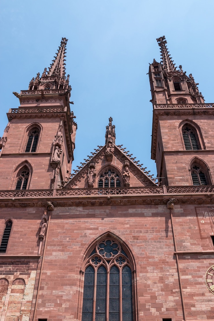 Foto basel, switzerland - june 23, 2017: view on basel minster, é um dos principais marcos e atrações turísticas da cidade suíça de basel. paisagem de verão, clima ensolarado, céu azul e dia ensolarado