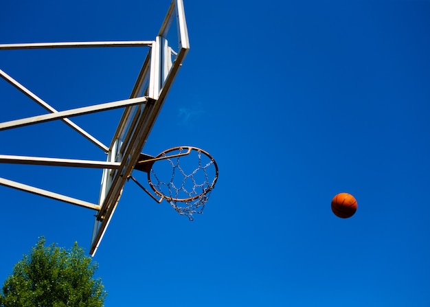 Basketball-Rückwand mit einem Ring auf der Straße auf dem Spielplatz vor dem Hintergrund des Himmels