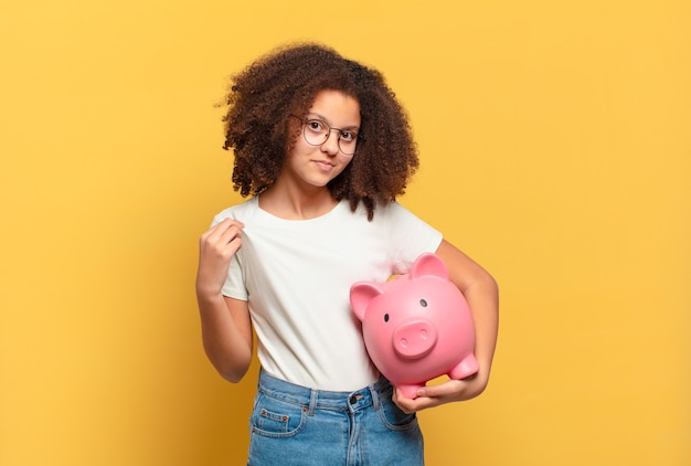 Bastante adolescente afro que parece serio, severo, disgustado y enojado mostrando la palma abierta haciendo gesto de parada. concepto de ahorro