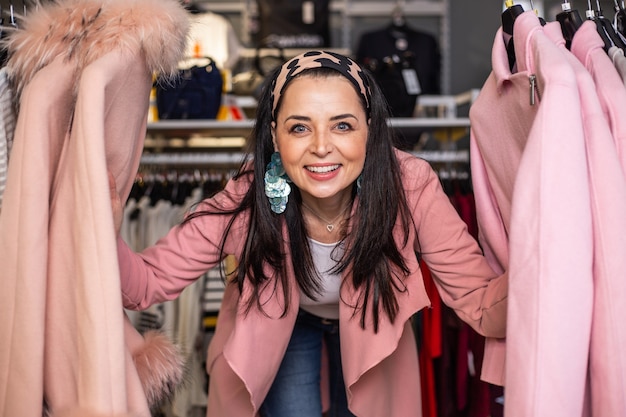 Foto bastante joven disfrutando y divirtiéndose con las compras en la tienda o boutique, retrato en una tienda