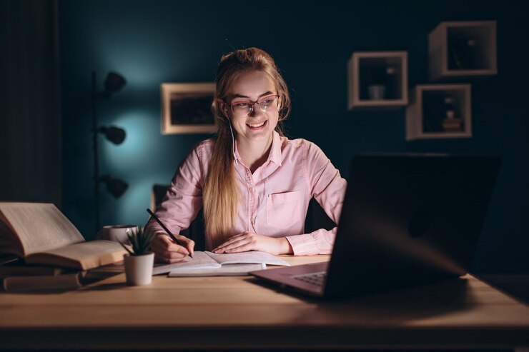 Bastante joven estudiante estudiando en la noche