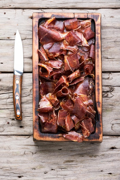 Basturma o cecina de vacuno. Cecina de carne de caballo sobre tabla de cortar. Cocina armenia