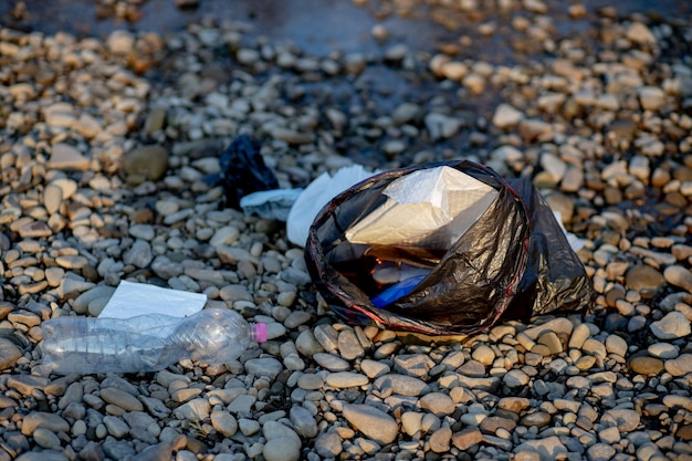 Basura cerca del río. Orilla de la contaminación ambiental.